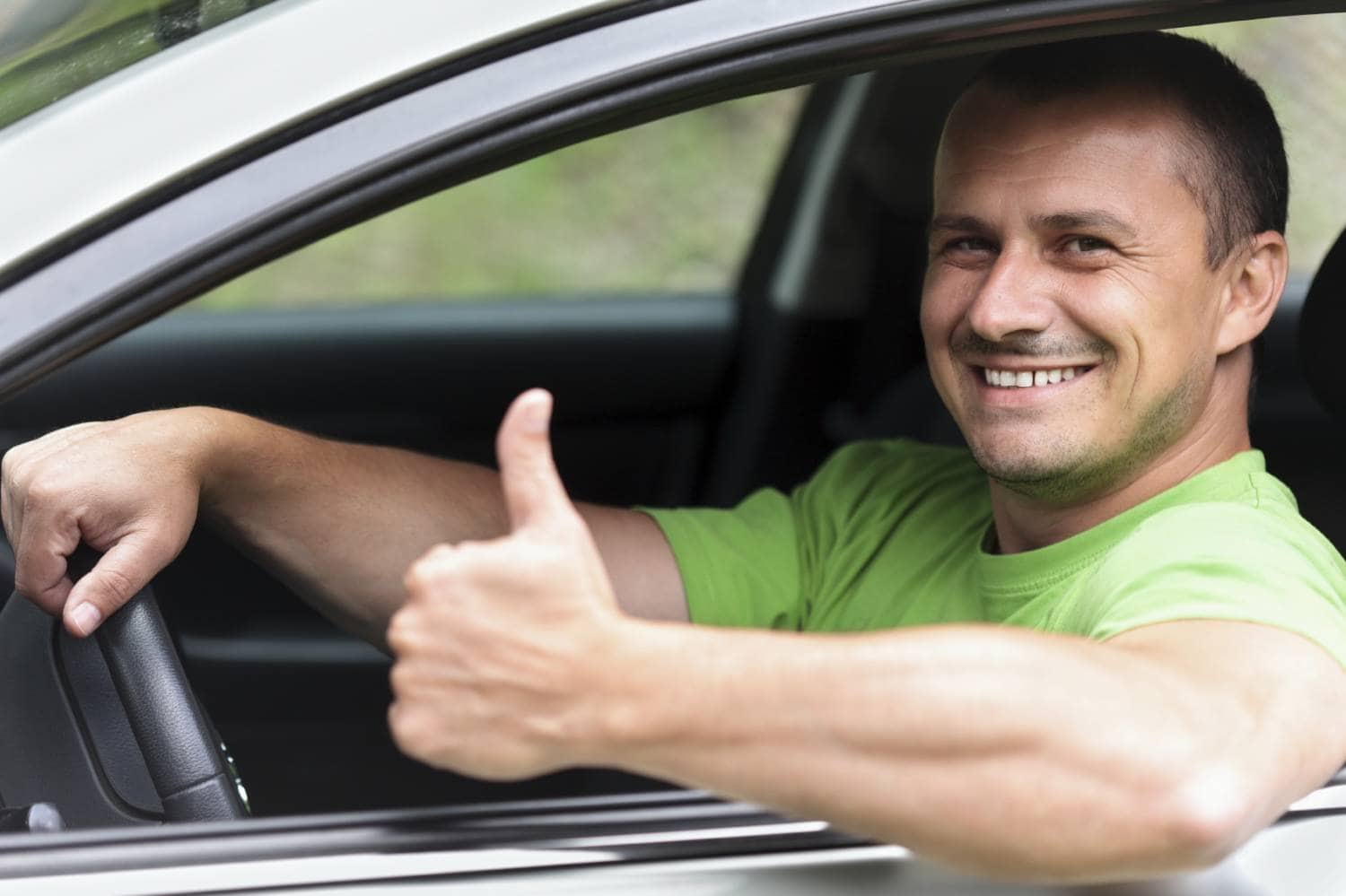 Guy with thumbs up driving a car he Novated Lease Company - How to Choose a good one